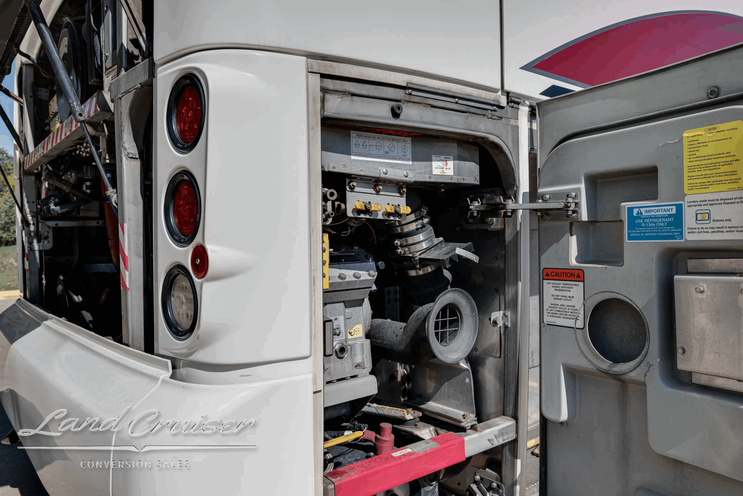 Rear lamp panel and engine access door open on the motorcoach.