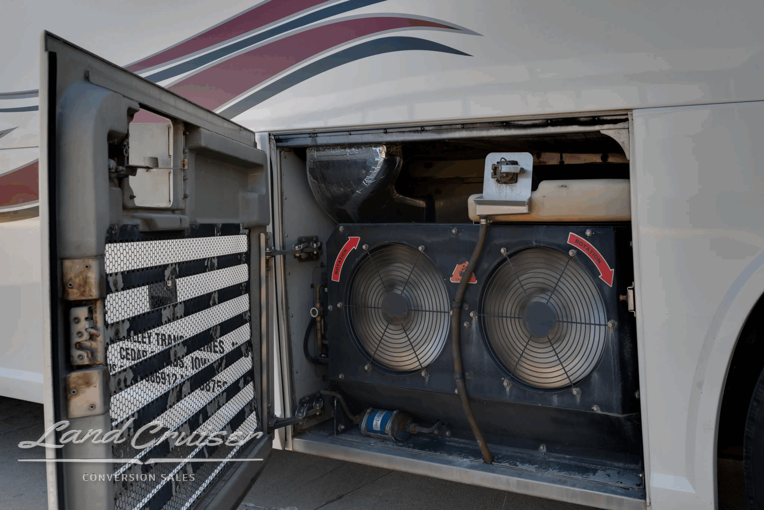 Dual HVAC condenser fans in curb-side equipment bay.