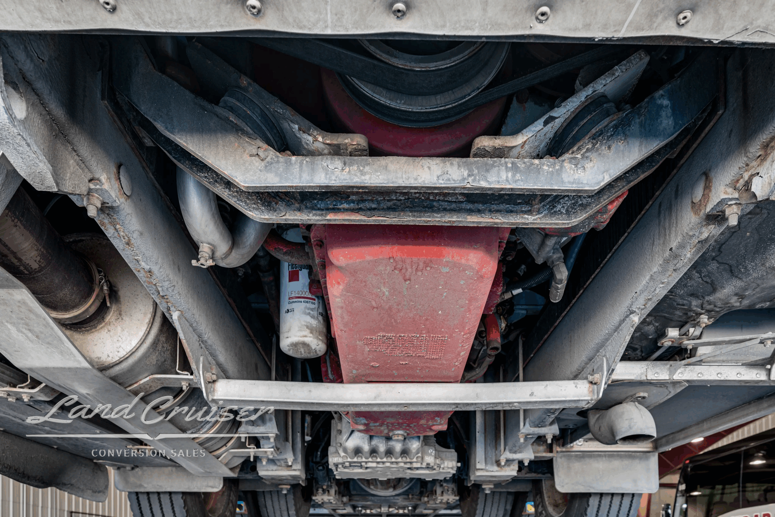 Undercarriage view of crossmember and driveline.