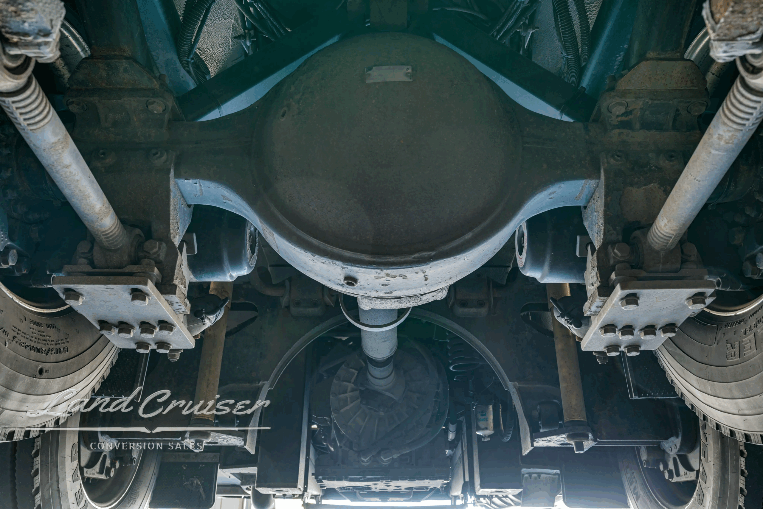 Rear drive-axle differential housing and suspension arms.