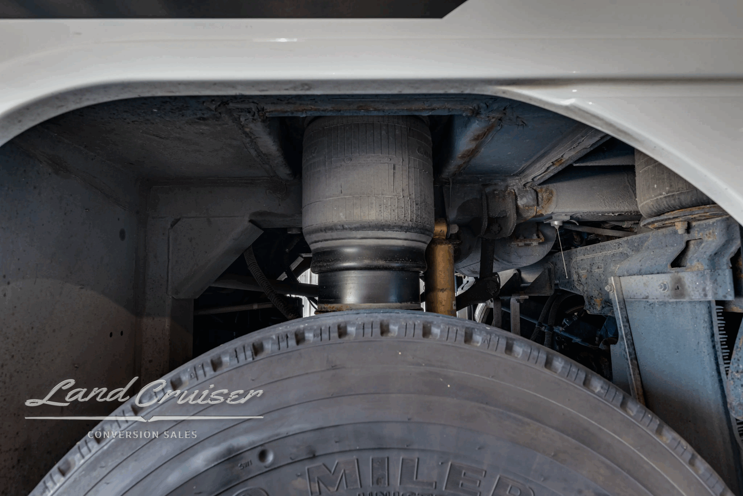 Rear suspension air bag and brake components near tag/drive area.