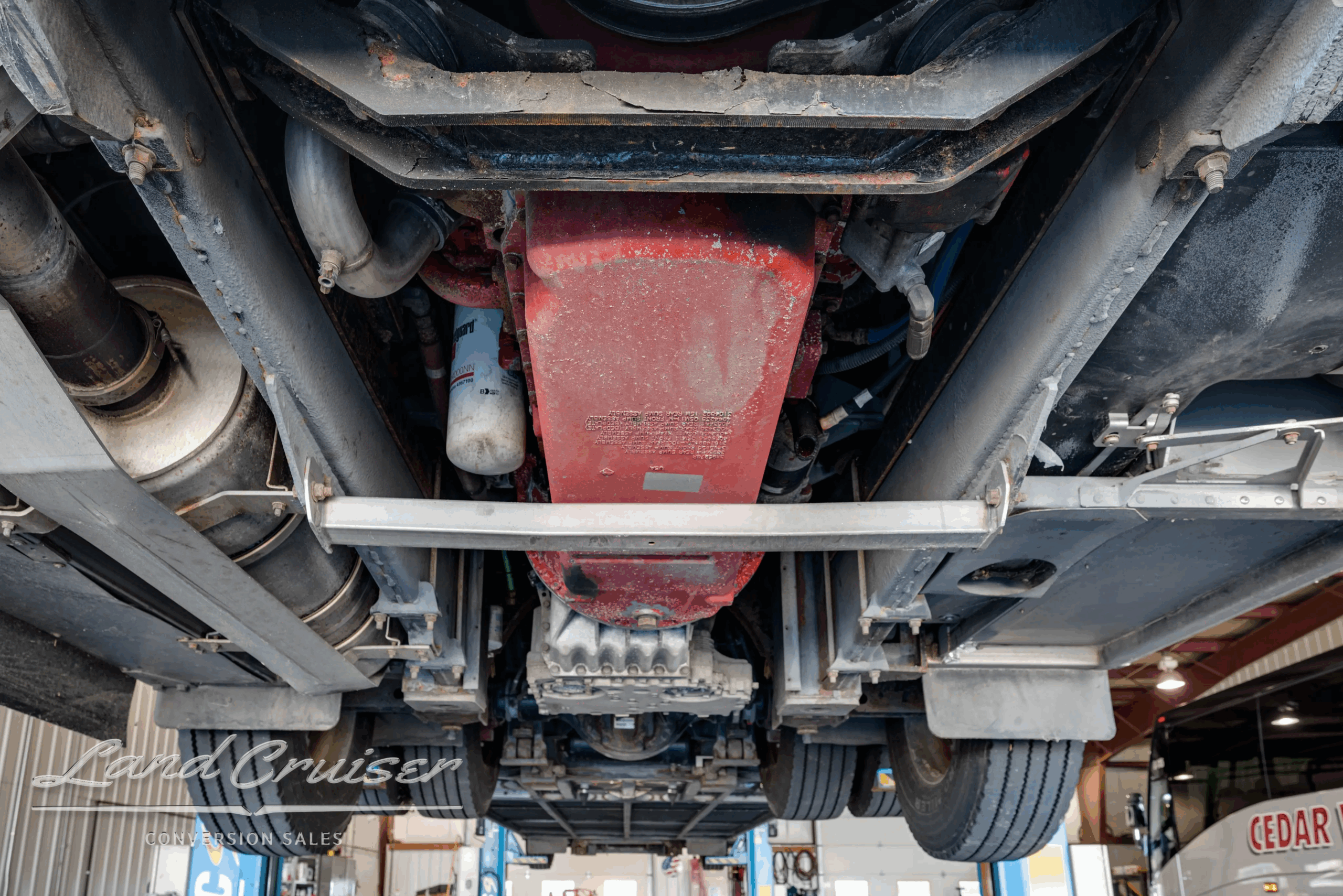 Undercarriage crossmember and steering linkage.