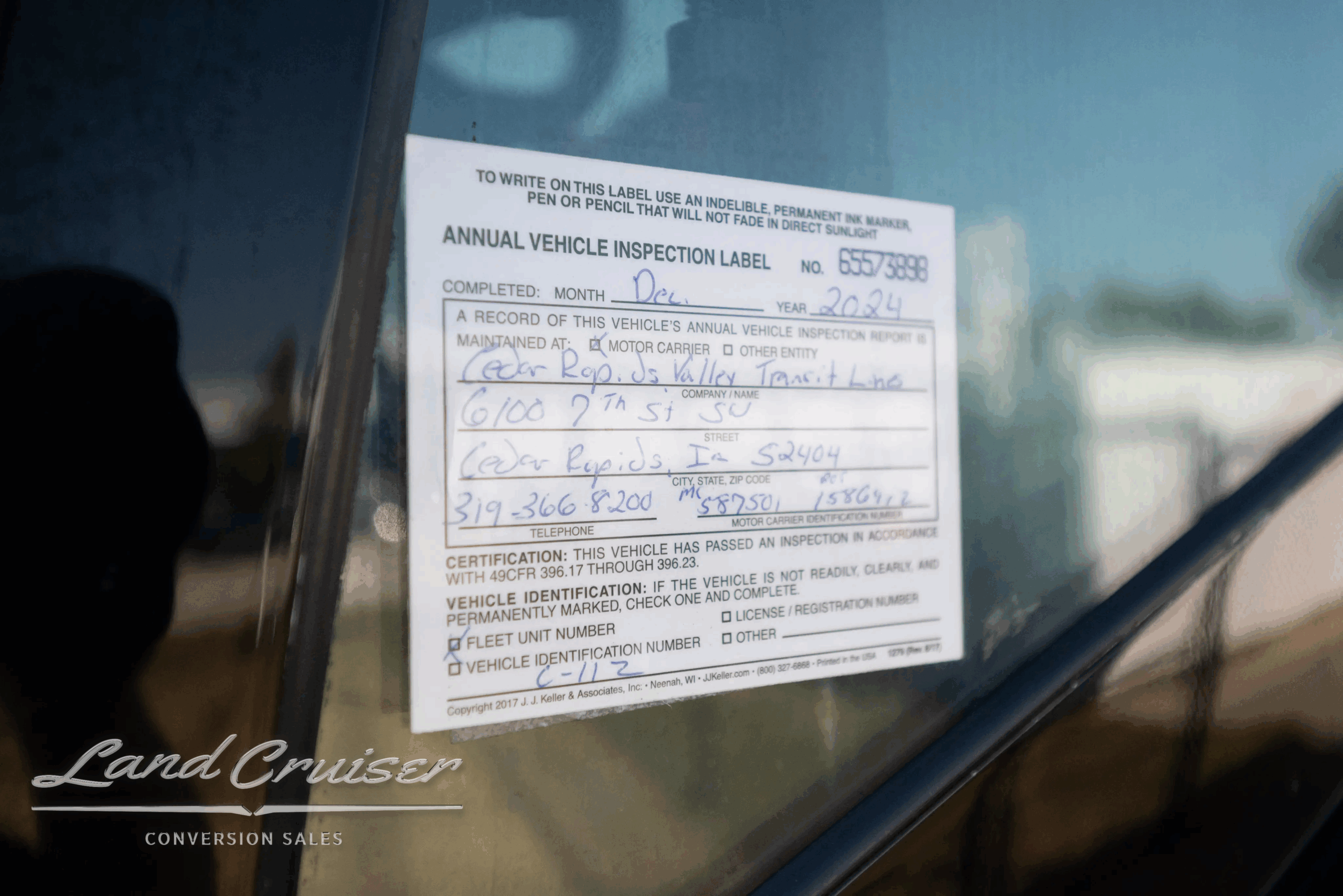 Annual vehicle inspection label on window.