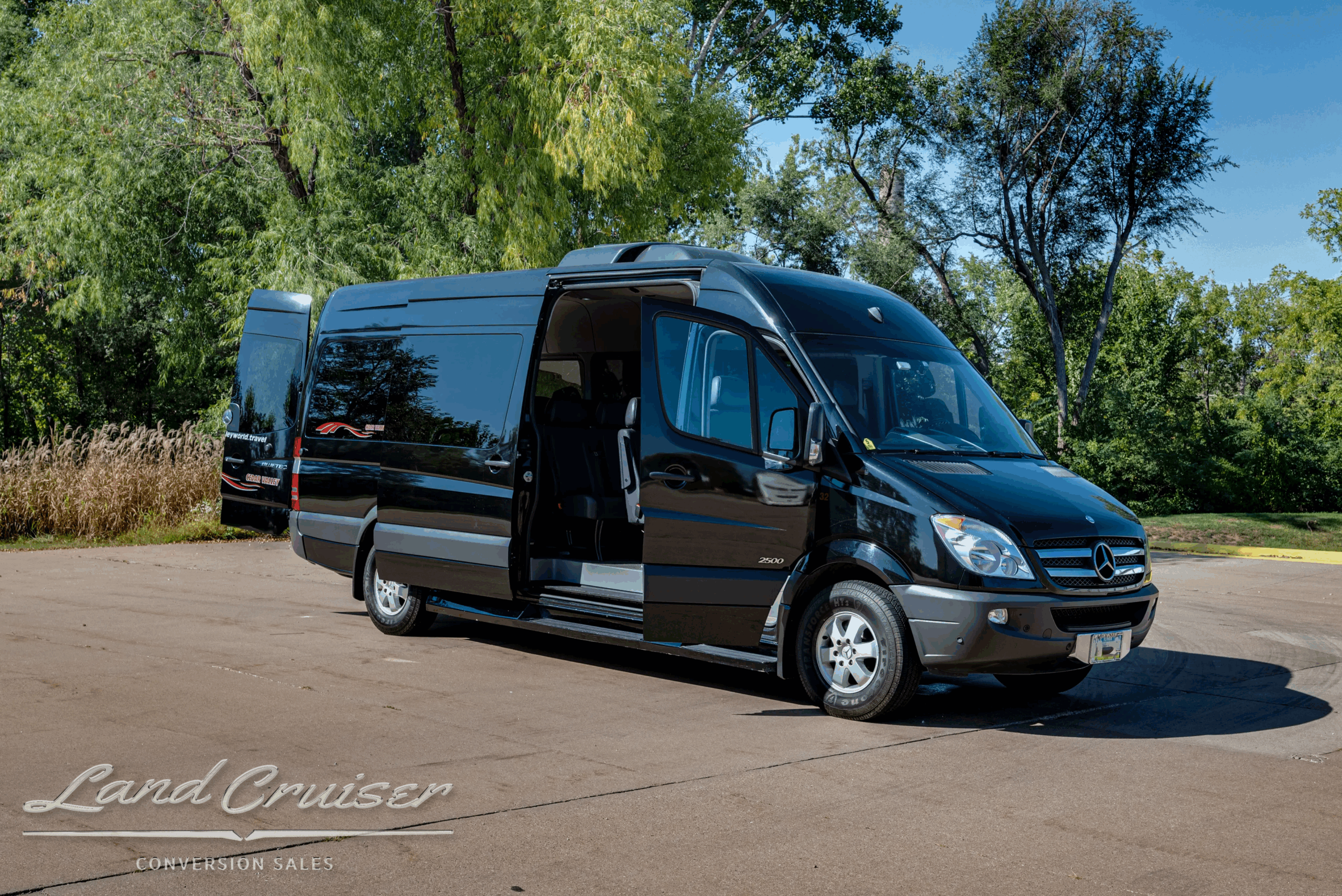 Passenger-side front three-quarter with sliding door open and running boards.