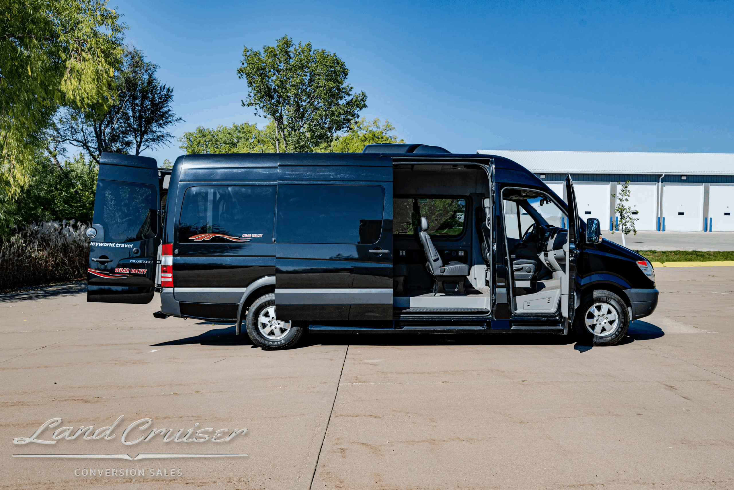 Passenger-side profile of 12-passenger Sprinter with side door open.
