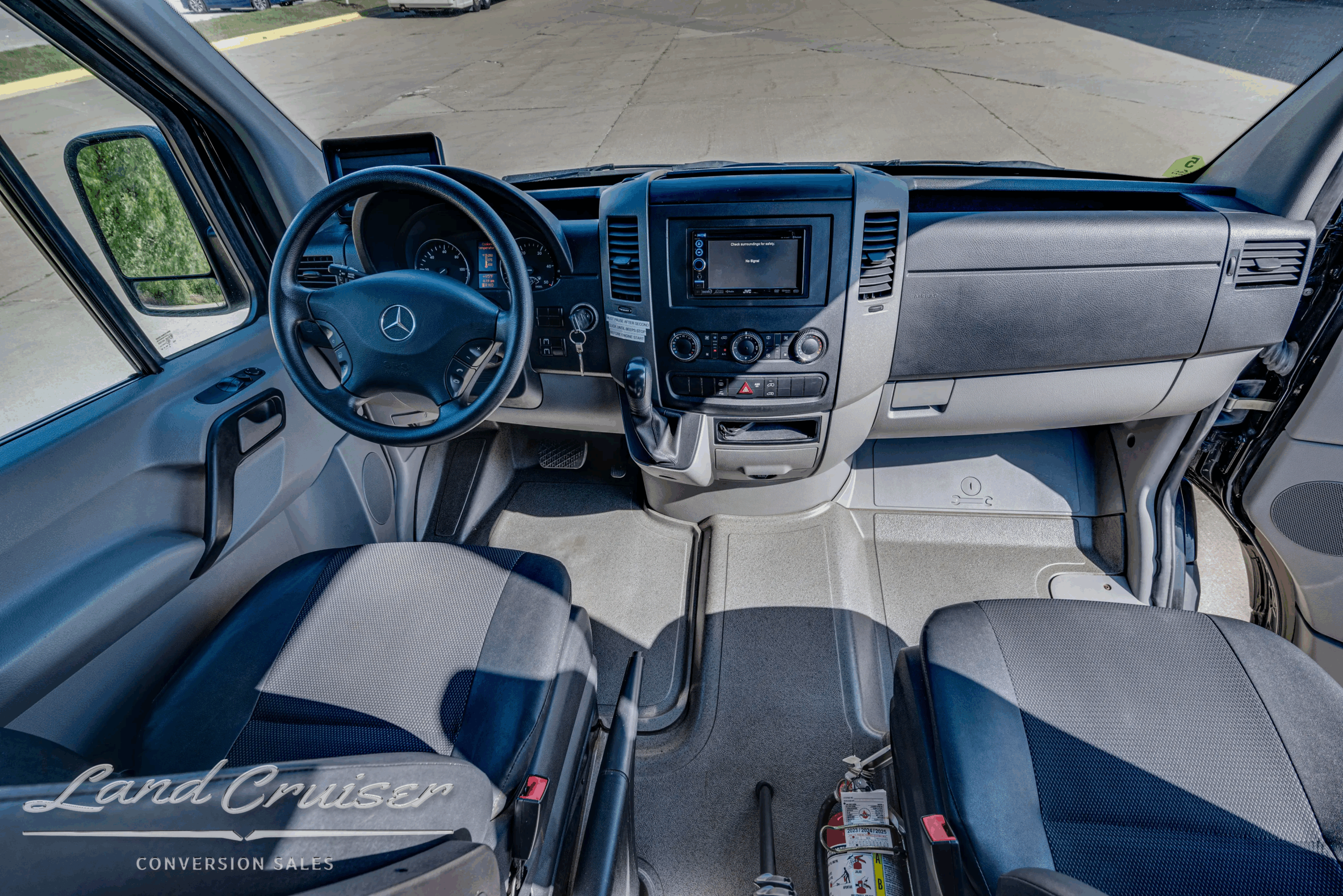 Driver cockpit and dashboard of Sprinter 2500 with controls and infotainment.