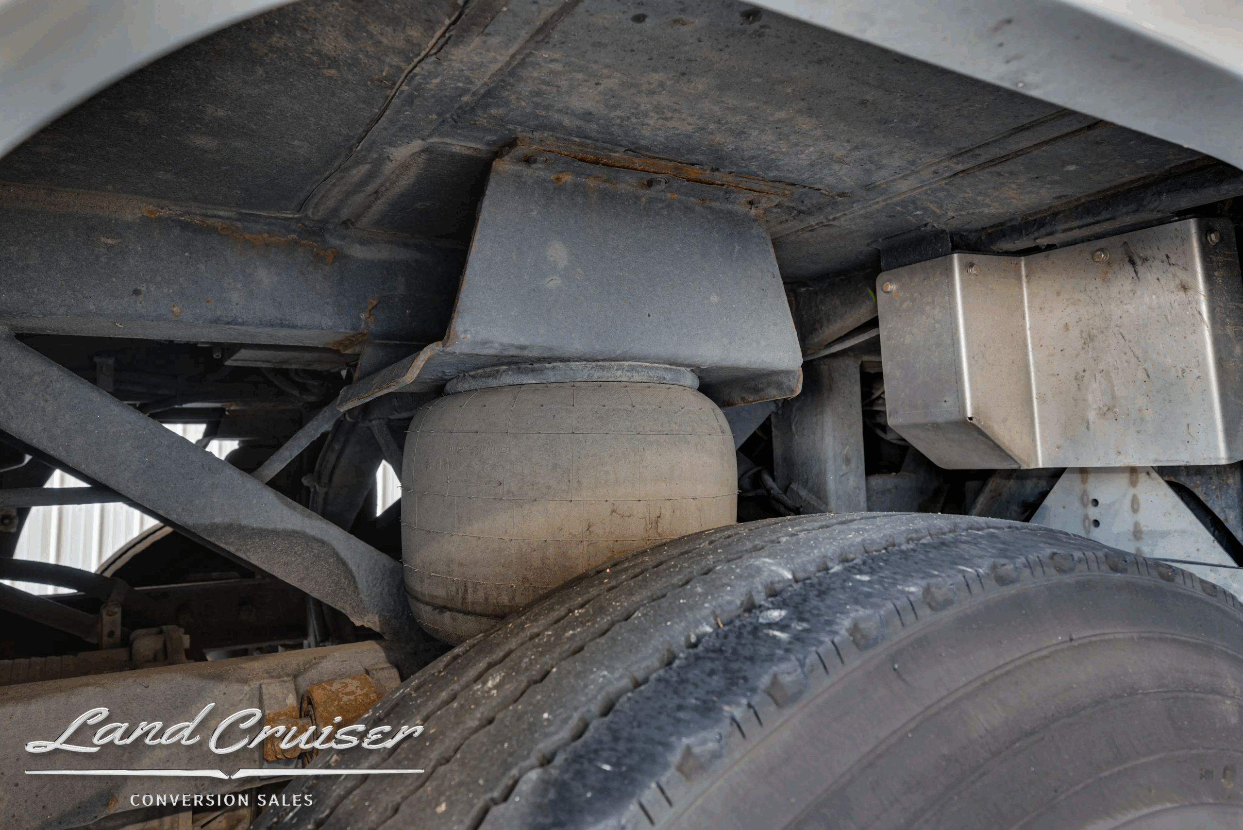 Air bag and suspension hardware inside wheel well.