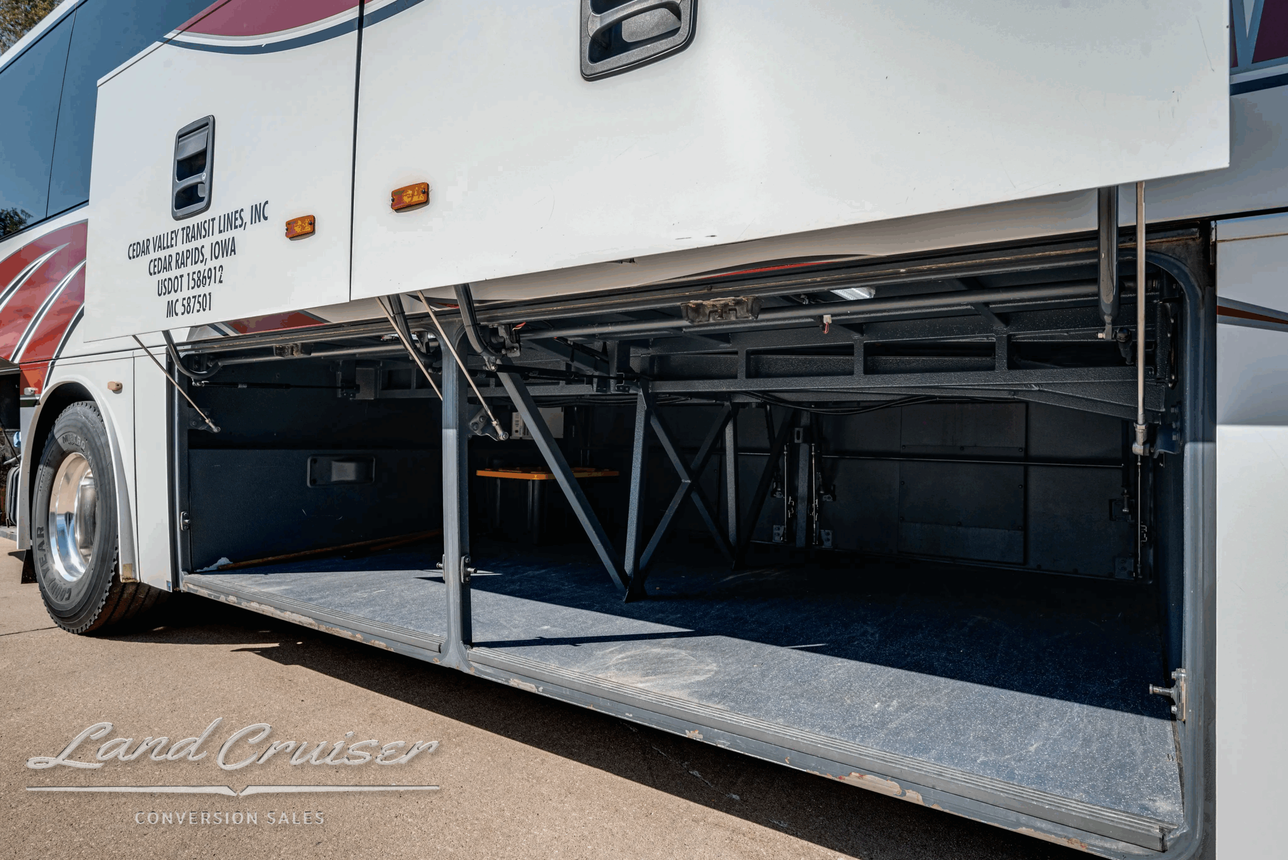 Curb-side luggage compartments open with slide tray.