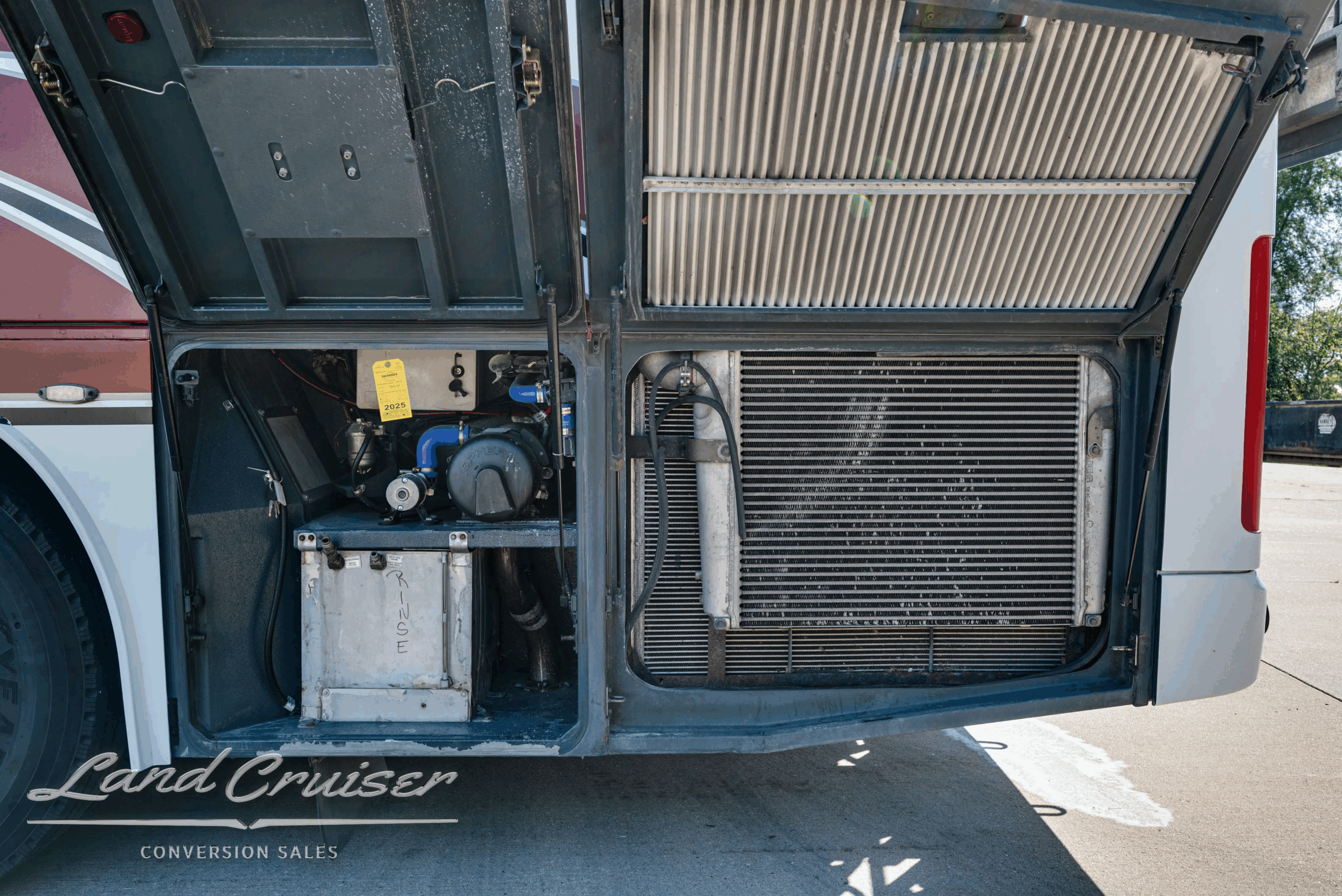 Rear service bay with batteries and condenser assembly.