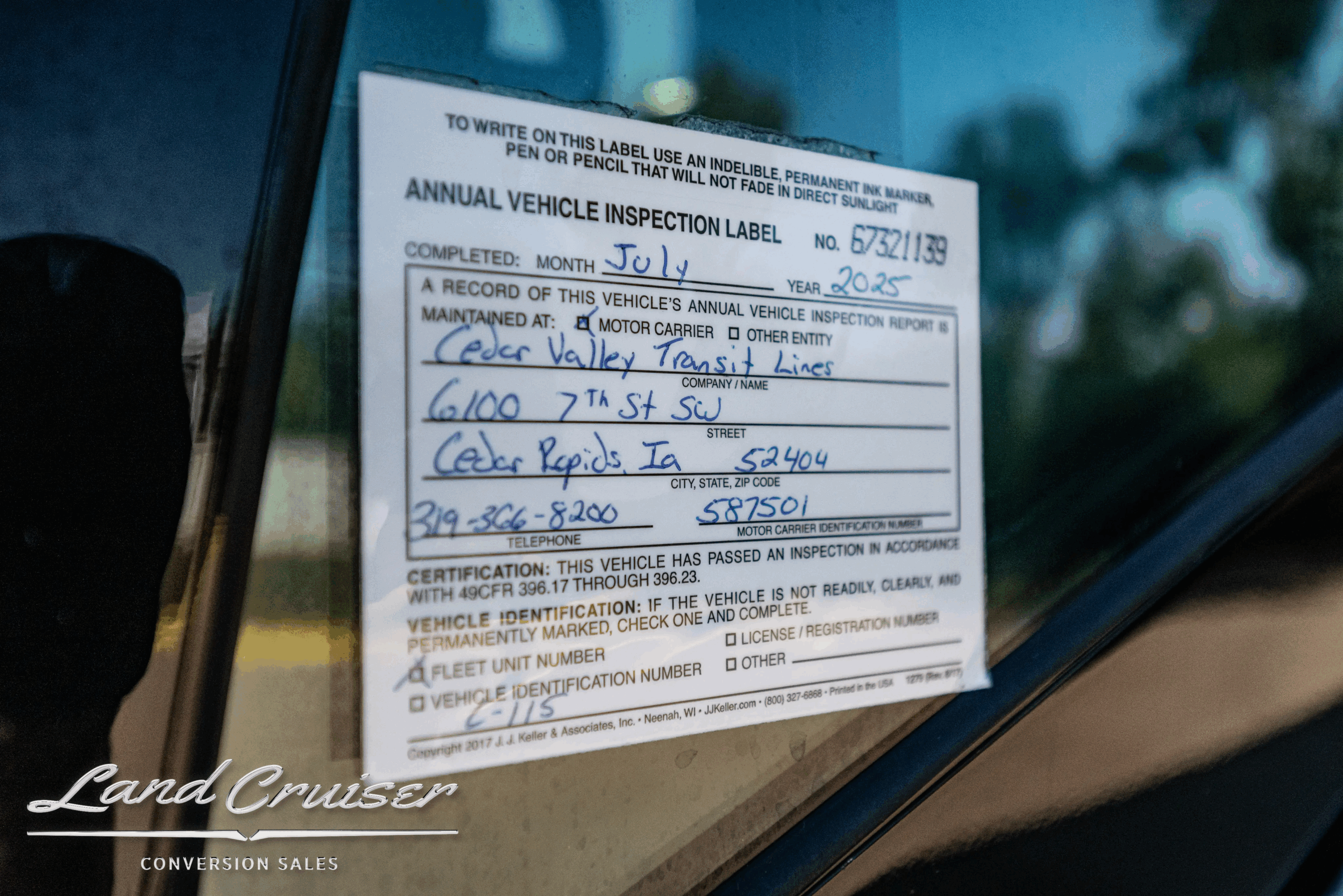 Annual vehicle inspection label on window.