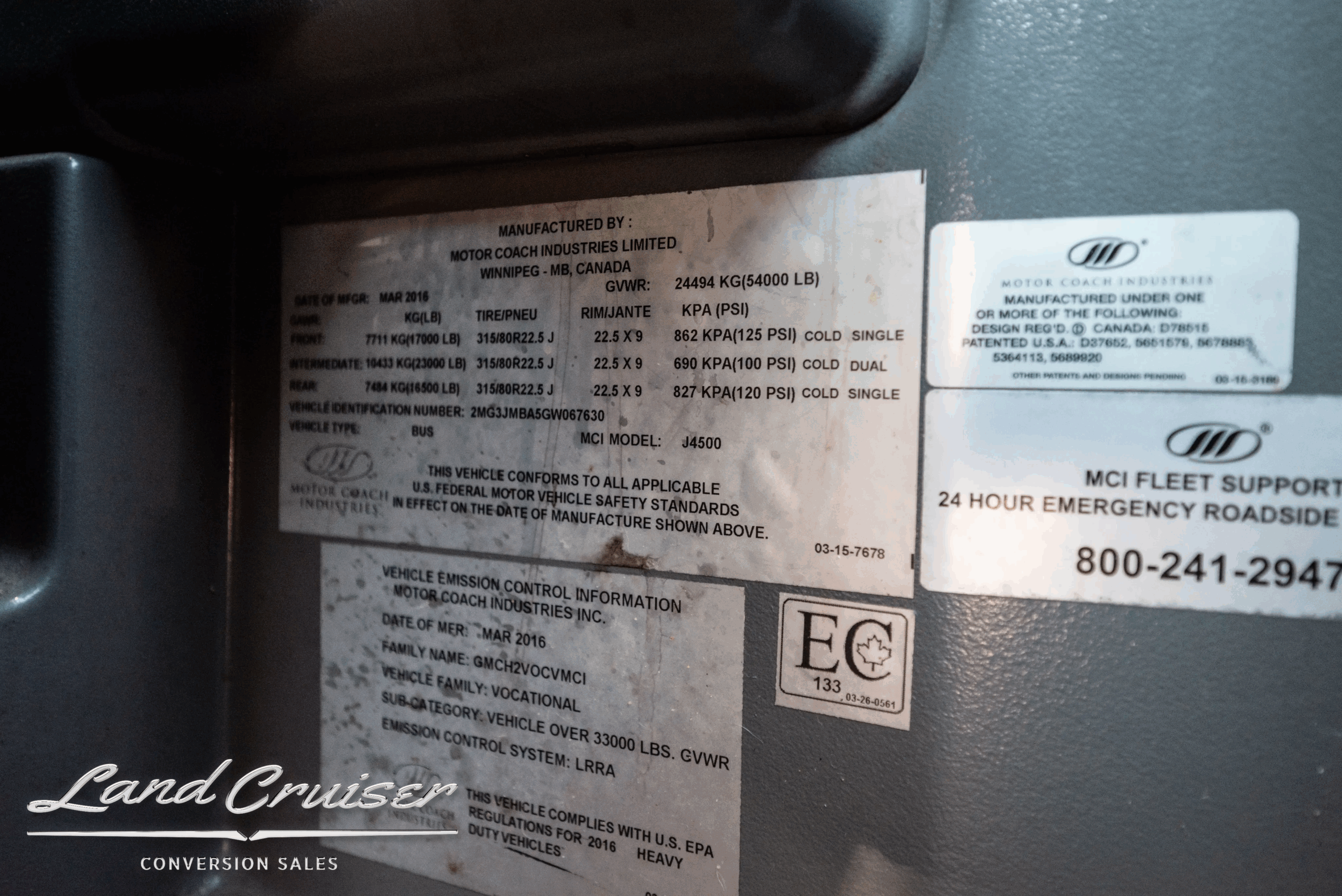 Manufacturer/VIN specification labels and build information plate inside the coach.