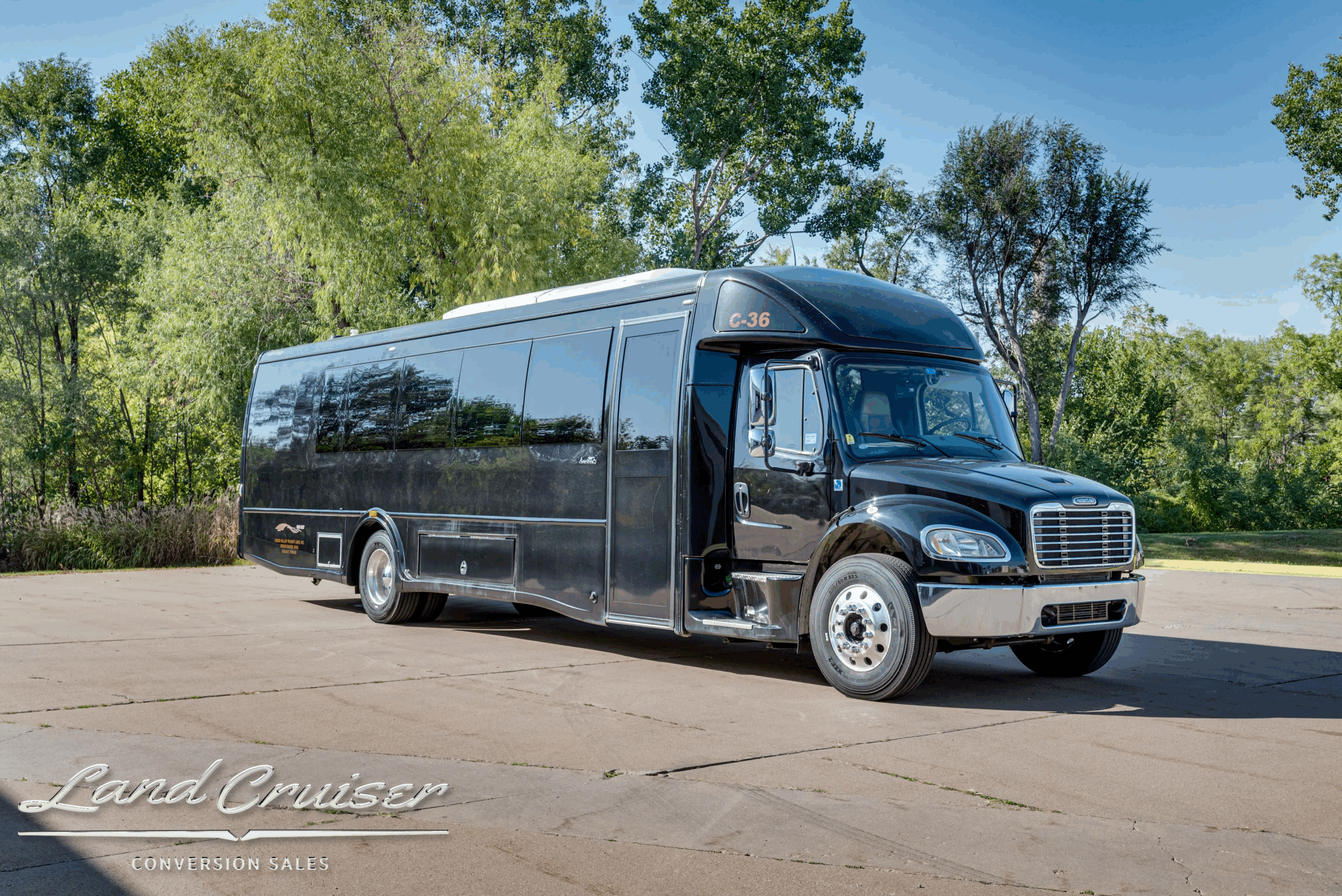 Front-right three-quarter view highlighting Ameritrans body and entry door.