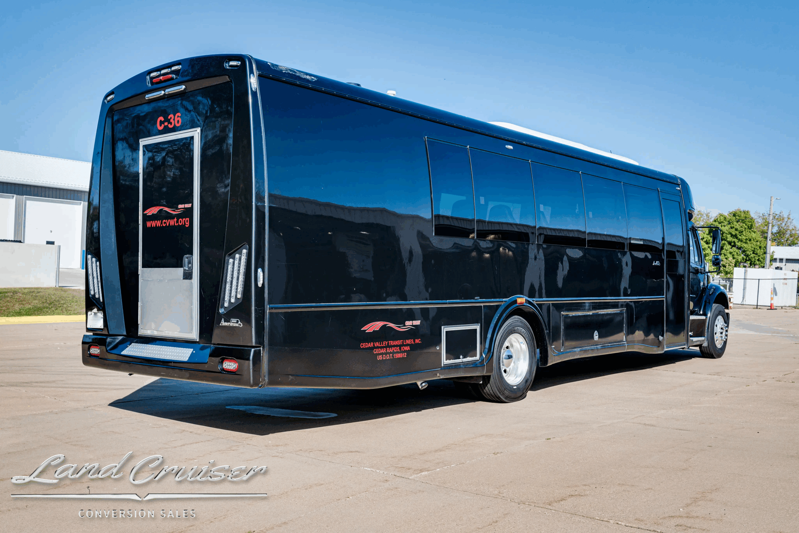 Rear passenger-side three-quarter of the Freightliner shuttle bus.