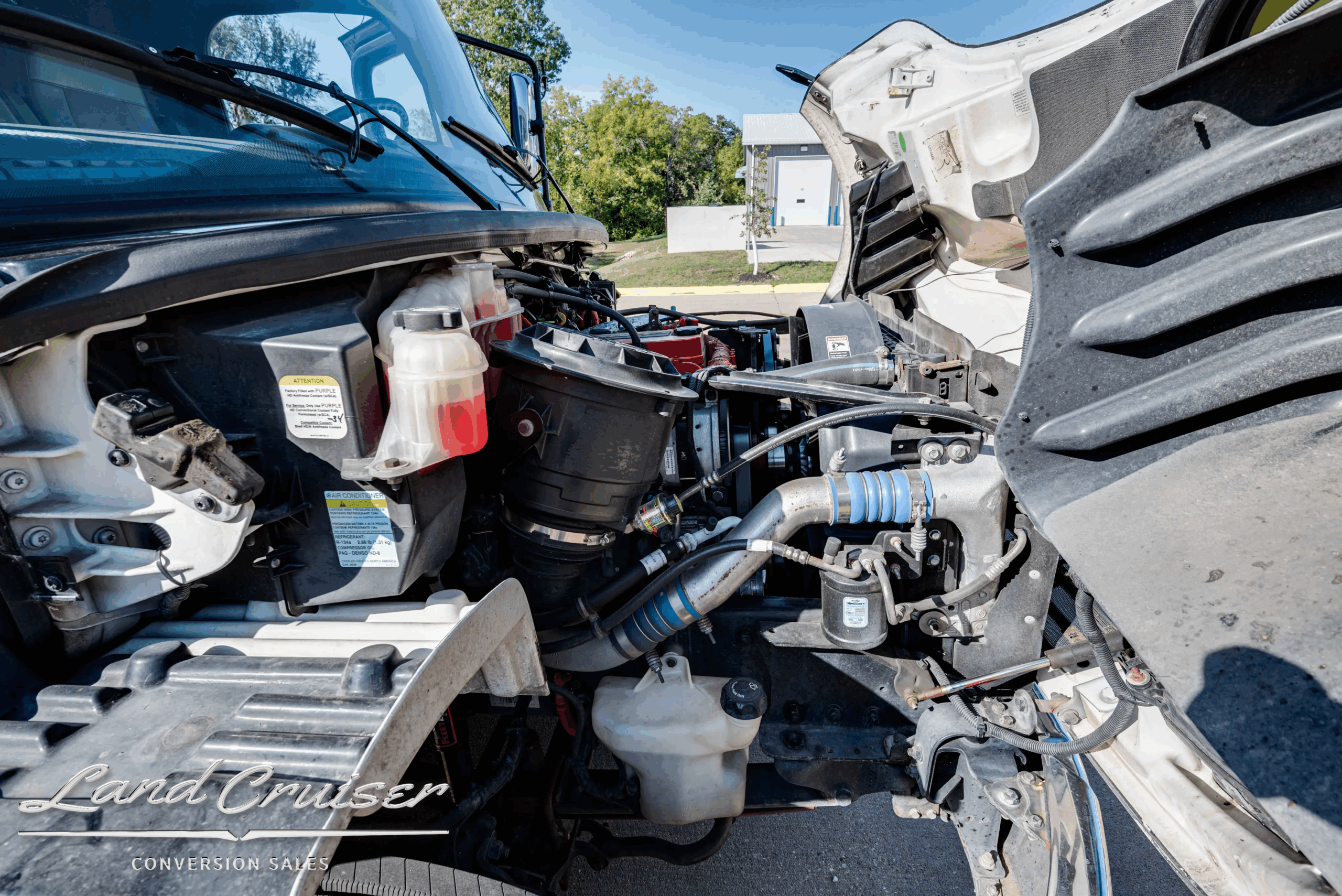 Engine compartment detail showing hoses and components on the Freightliner coach.