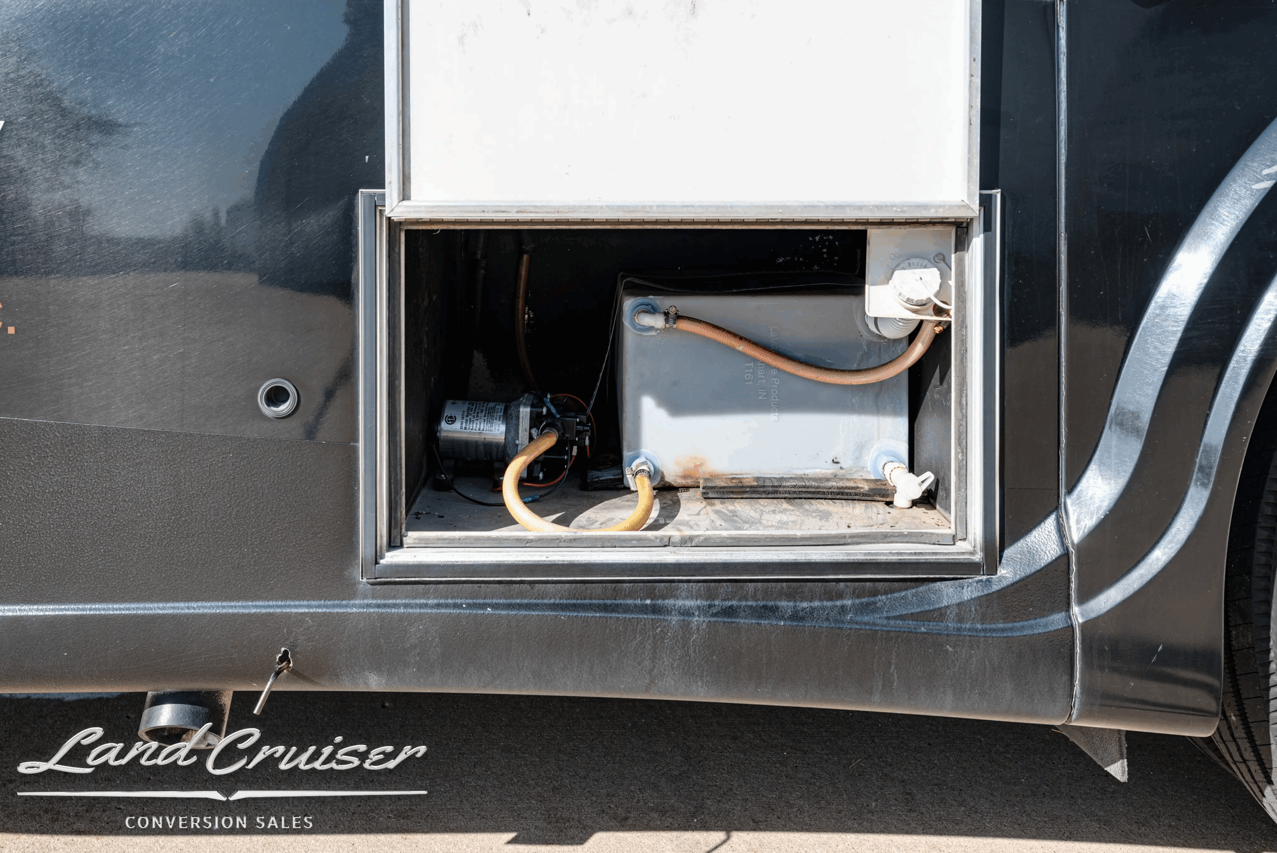 Utility compartment with shore-power style connection and equipment access.