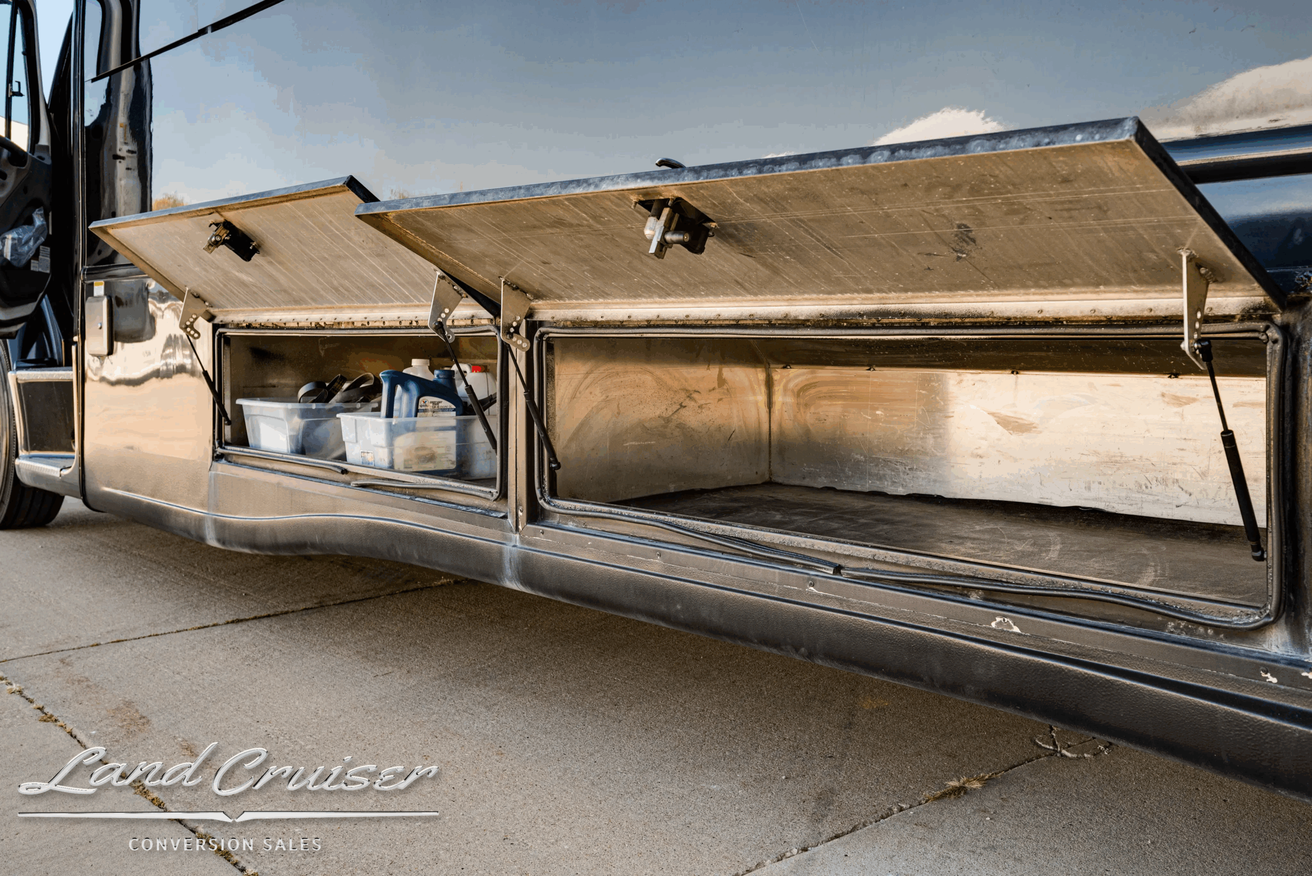 Long under-floor storage bay interior for bags and gear.