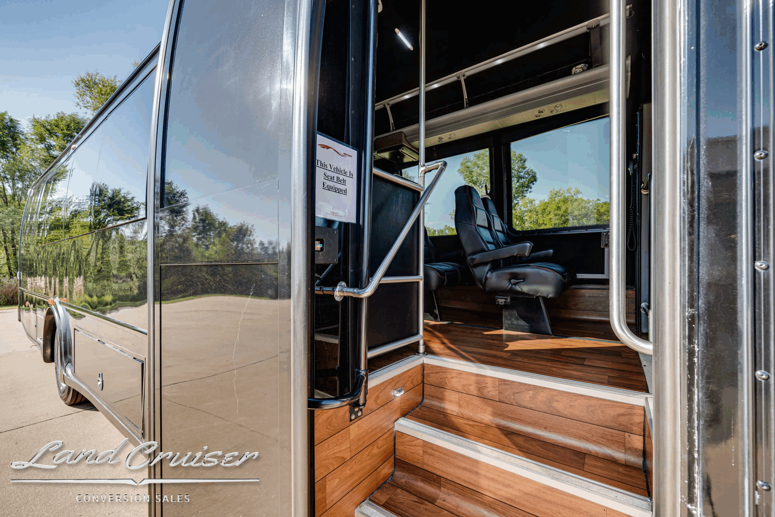 Passenger-side exterior detail near entry area and luggage bays.