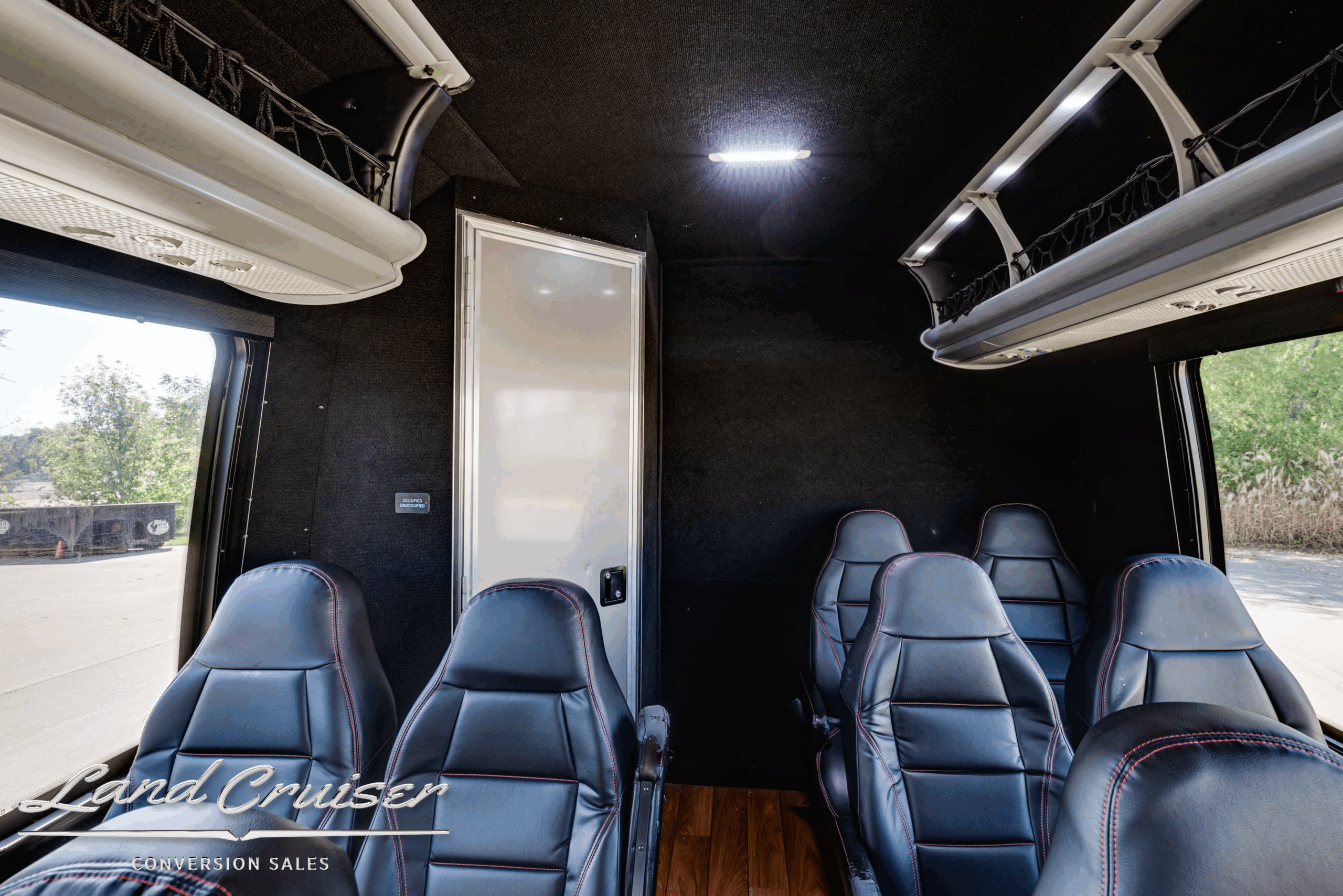 Rear interior bulkhead and seating inside the 2015 Freightliner Ameritrans passenger bus.